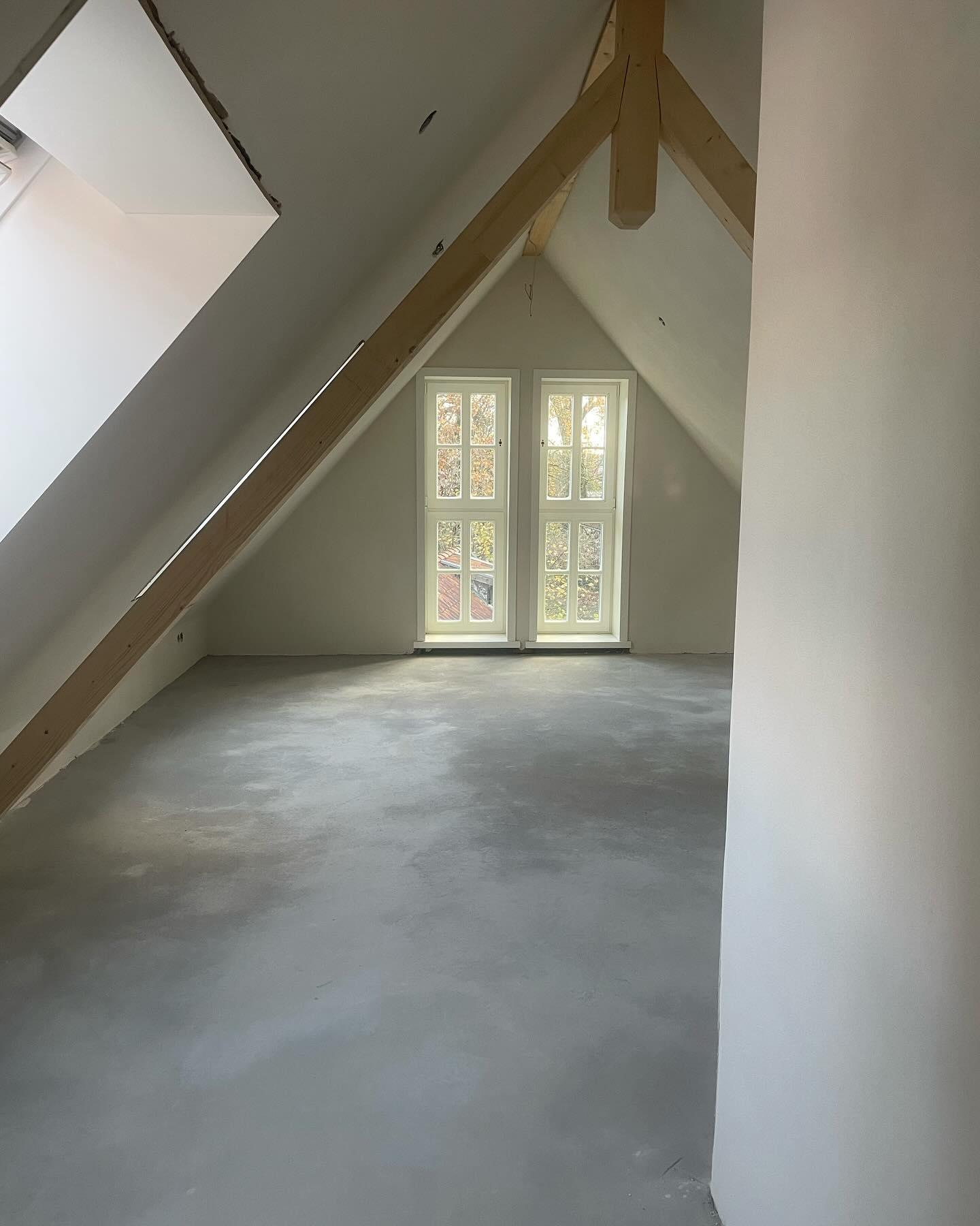 Ausgebauter Dachraum mit sichtbaren Holzbalken und natürlichen Baustoffen